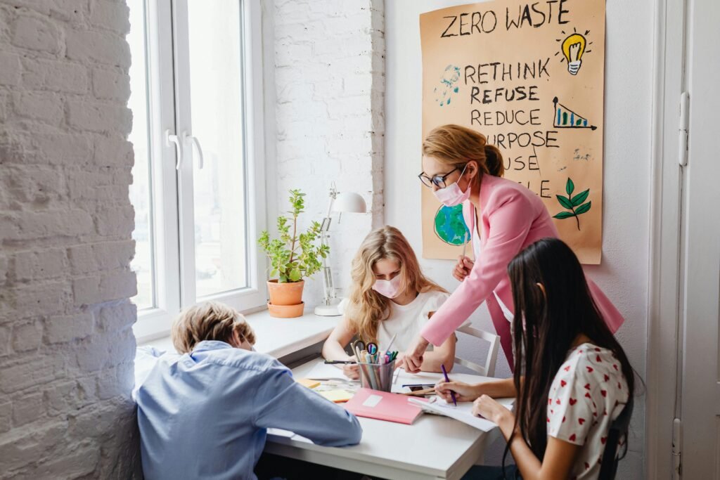 A teacher guides students in a classroom project focused on zero waste education, promoting sustainability.