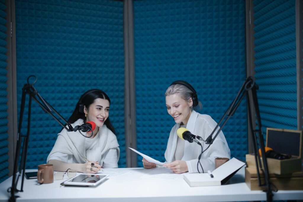 pexels-photo-7598562-7598562 Two women recording a podcast in a soundproof studio with professional equipment.
