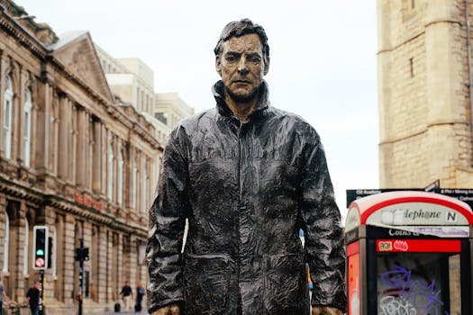 Bronze statue with city backdrop in Newcastle, England.